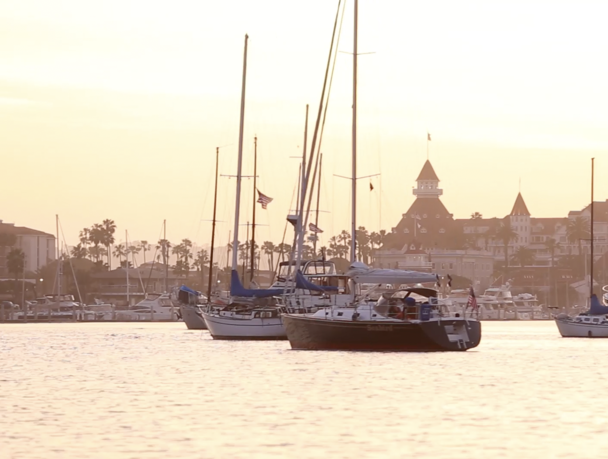 A whale watching boat on calm water at sunset off San Diego